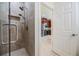 Bathroom showcases a glass enclosed shower with dual shower heads, stylish fixtures, and convenient access to the kitchen at 3429 Heards Ferry Dr, Tampa, FL 33618