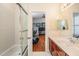 Bathroom featuring shower, vanity, and a glimpse into a home office, offering convenience and style at 3429 Heards Ferry Dr, Tampa, FL 33618