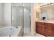 Spacious bathroom with a tub, glass-enclosed shower, and vanity with ample counter space at 3429 Heards Ferry Dr, Tampa, FL 33618