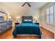 Inviting bedroom with hardwood floors, a blue bedspread, and stylish decor at 3429 Heards Ferry Dr, Tampa, FL 33618