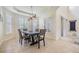 Bright dining room features modern lighting, neutral walls, and lots of natural light from windows with plantation shutters at 3429 Heards Ferry Dr, Tampa, FL 33618