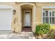 Welcoming front entrance featuring a brick walkway, covered entryway, and stylish exterior lighting at 3429 Heards Ferry Dr, Tampa, FL 33618