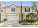 Charming townhome with a two-car garage, manicured landscaping, and a welcoming entrance at 3429 Heards Ferry Dr, Tampa, FL 33618