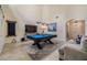 Spacious game room featuring a pool table, comfortable seating, and bright neutral paint at 3429 Heards Ferry Dr, Tampa, FL 33618