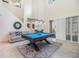 Open-concept game room with a pool table, neutral paint, and sliding doors to the patio at 3429 Heards Ferry Dr, Tampa, FL 33618