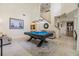Bright game room featuring a pool table, neutral paint, and access to the kitchen and staircase at 3429 Heards Ferry Dr, Tampa, FL 33618