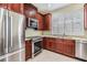 This updated kitchen is equipped with stainless steel appliances, dark wood cabinets and granite countertops at 3429 Heards Ferry Dr, Tampa, FL 33618