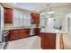 Bright kitchen with dark wood cabinetry, granite countertops, stainless steel appliances, and a serving bar at 3429 Heards Ferry Dr, Tampa, FL 33618