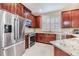 Updated kitchen features granite countertops, stainless steel appliances, and gorgeous, dark-stained cabinets for ample storage at 3429 Heards Ferry Dr, Tampa, FL 33618