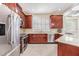 This kitchen has granite countertops, stainless steel appliances, and ample dark wood cabinetry for storage at 3429 Heards Ferry Dr, Tampa, FL 33618