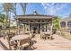 View of the wooden Lakeside Preserve community pavilion, featuring an outdoor fireplace and ample seating at 3429 Heards Ferry Dr, Tampa, FL 33618