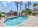 Sparkling community pool with sundeck, chaise lounges, and adjacent outdoor grilling and dining areas at 3429 Heards Ferry Dr, Tampa, FL 33618