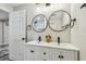 The bathroom features dual sinks, round mirrors, modern hardware, and new vanity at 3838 29Th N St, St Petersburg, FL 33714