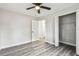 Bedroom with ensuite bath, closet, fan, gray wood flooring, and neutral walls at 3838 29Th N St, St Petersburg, FL 33714