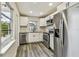 Modern kitchen with stainless steel appliances, white cabinets, and sleek countertops at 3838 29Th N St, St Petersburg, FL 33714