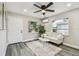 Inviting living room with large windows, sleek ceiling fan, and neutral color scheme at 3838 29Th N St, St Petersburg, FL 33714