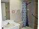 Bathroom featuring a shower-tub combo, vanity, and a shower curtain at 3861 Sailmaker Ln # 3861, Holiday, FL 34691