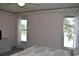 Bedroom with two windows and a floral wallpaper border near the ceiling at 3861 Sailmaker Ln # 3861, Holiday, FL 34691