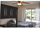 Comfortable bedroom with large window and a ceiling fan at 3861 Sailmaker Ln # 3861, Holiday, FL 34691