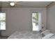 Bedroom featuring two windows with peaceful outdoor views and a floral wallpaper border at 3861 Sailmaker Ln # 3861, Holiday, FL 34691