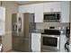 Well-equipped kitchen with stainless steel appliances, bright cabinetry, and durable countertops at 3861 Sailmaker Ln # 3861, Holiday, FL 34691