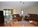 Cozy living room featuring hardwood floors, leather furniture, and access to a screened-in porch at 3861 Sailmaker Ln # 3861, Holiday, FL 34691