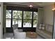 Cozy sunroom offering views of the lake, with comfortable seating and tile flooring at 3861 Sailmaker Ln # 3861, Holiday, FL 34691