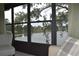 Relaxing sunroom view of the lake, providing ample natural light and comfortable seating at 3861 Sailmaker Ln # 3861, Holiday, FL 34691