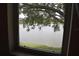 View of a lake framed by tree branches at 3861 Sailmaker Ln # 3861, Holiday, FL 34691