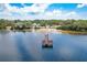 Waterfront aerial showcases a private dock on serene waters, perfect for boating and fishing at 420 Hanby St, Crystal Beach, FL 34681