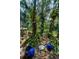 Backyard with beautiful landscaping, colorful decor, outdoor lighting, and comfortable seating areas at 420 Hanby St, Crystal Beach, FL 34681