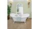 Bathroom featuring a claw foot tub, window, and tile flooring at 420 Hanby St, Crystal Beach, FL 34681