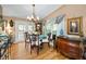 Bright dining room featuring a chandelier, natural light, and hardwood floors at 420 Hanby St, Crystal Beach, FL 34681