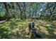 Two-story home nestled among mature trees and lush landscaping at 420 Hanby St, Crystal Beach, FL 34681