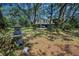 Two-story home with covered parking nestled among mature trees and lush landscaping at 420 Hanby St, Crystal Beach, FL 34681