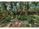 Secluded garden featuring an assortment of lush foliage, decorative statues and unique potting arrangements at 420 Hanby St, Crystal Beach, FL 34681