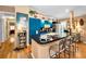 Bright kitchen features a black granite countertop with barstool seating and blue cabinets for a modern design at 420 Hanby St, Crystal Beach, FL 34681