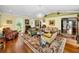 Bright living room featuring hardwood floors, multiple seating areas, and a chandelier at 420 Hanby St, Crystal Beach, FL 34681