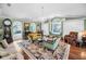 Bright living room featuring hardwood floors, large windows, and a chandelier at 420 Hanby St, Crystal Beach, FL 34681