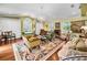 Cozy living room featuring hardwood floors, large windows, and a chandelier at 420 Hanby St, Crystal Beach, FL 34681
