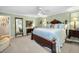 Bright main bedroom featuring a large bed, hardwood floors, and natural light at 420 Hanby St, Crystal Beach, FL 34681