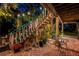 Charming outdoor patio with cozy string lights and lush landscaping, perfect for relaxing or entertaining at 420 Hanby St, Crystal Beach, FL 34681
