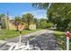 Charming neighborhood street with palm trees, scenic views, and a building in a safe location at 420 Hanby St, Crystal Beach, FL 34681