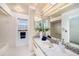 Bright bathroom featuring a vanity with mosaic tile accents, large mirrors, and ample lighting at 4270 Boston Cir, New Port Richey, FL 34653