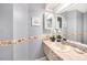 Cozy powder room with tiled walls, countertop, and decorative seashell trim at 4270 Boston Cir, New Port Richey, FL 34653