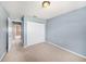 This bedroom features neutral carpet, blue walls and a closet for maximum storage at 4270 Boston Cir, New Port Richey, FL 34653