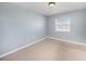 A simple bedroom with carpeted floor and a window providing ample natural light at 4270 Boston Cir, New Port Richey, FL 34653