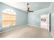 Cozy bedroom with large window, ceiling fan, and carpet flooring at 4270 Boston Cir, New Port Richey, FL 34653