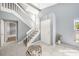 Bright foyer featuring tile flooring, staircase, and stylish accents at 4270 Boston Cir, New Port Richey, FL 34653
