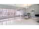 Open living room with tile flooring, sliding glass doors to outdoor space, and stylish decor at 4270 Boston Cir, New Port Richey, FL 34653